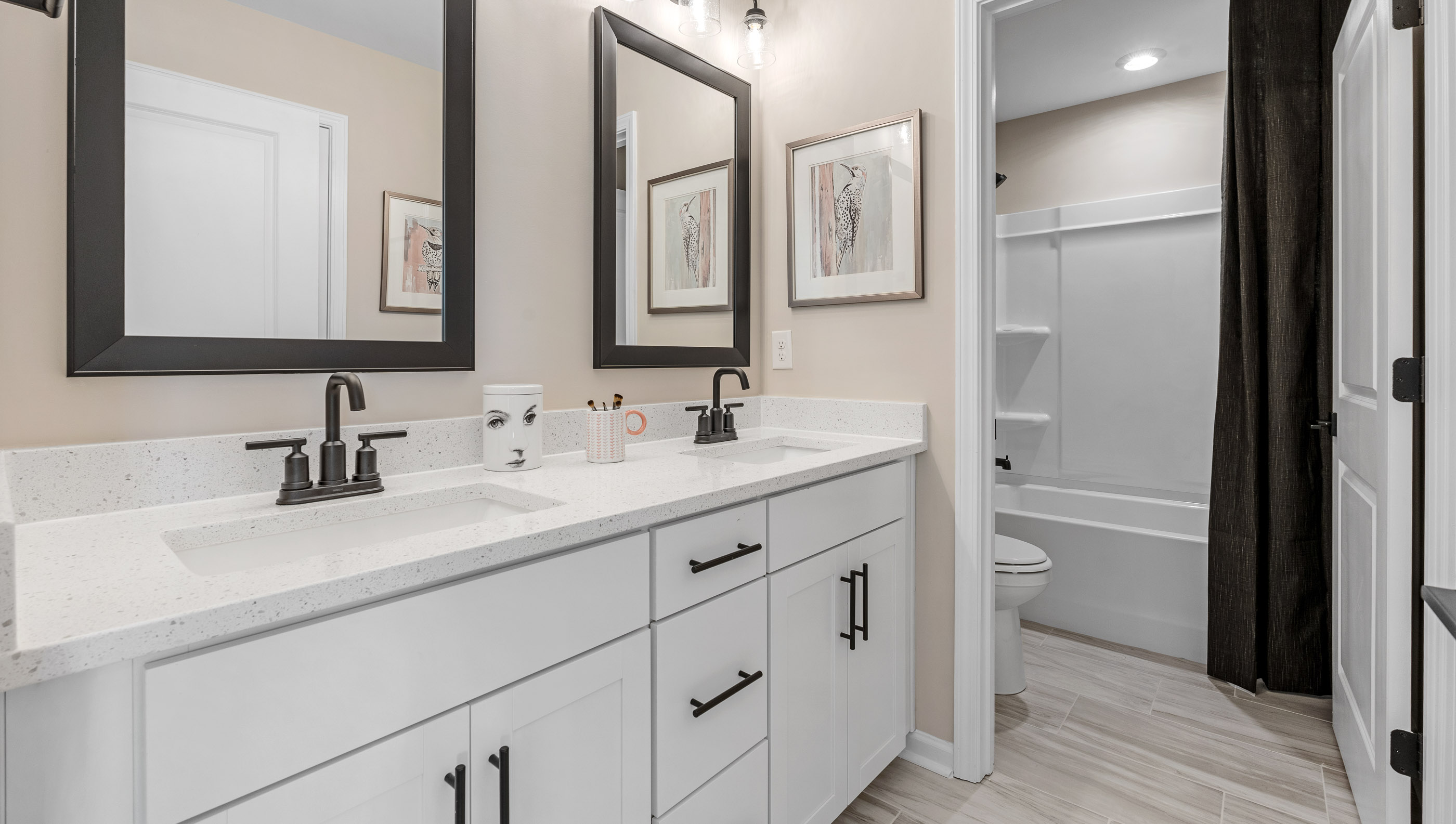 Bathroom with double vanity sinks and shower.