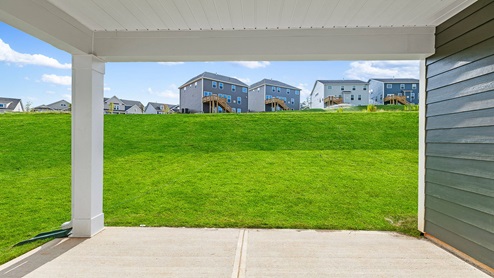 Back covered patio with large backyard.