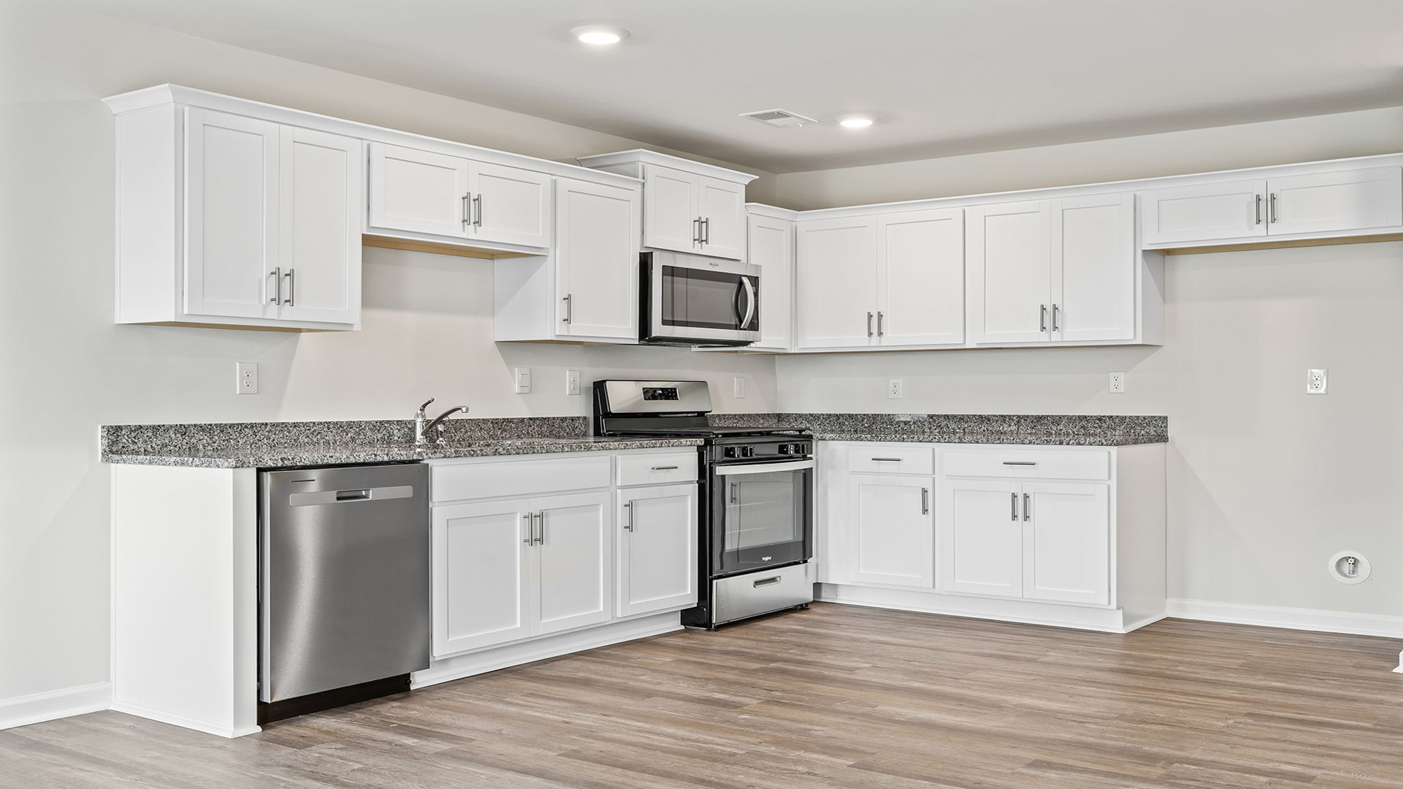 White cabinetry with granite countertops.