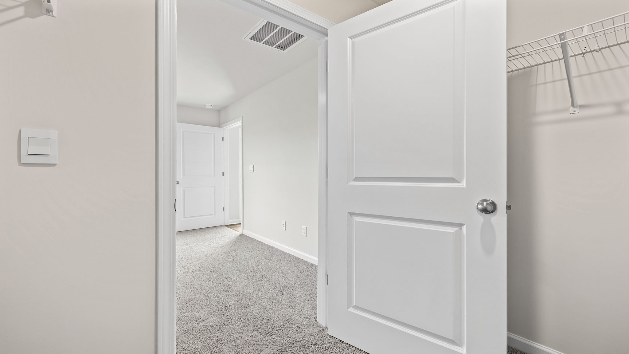 Primary bedroom view of walk-in closet.