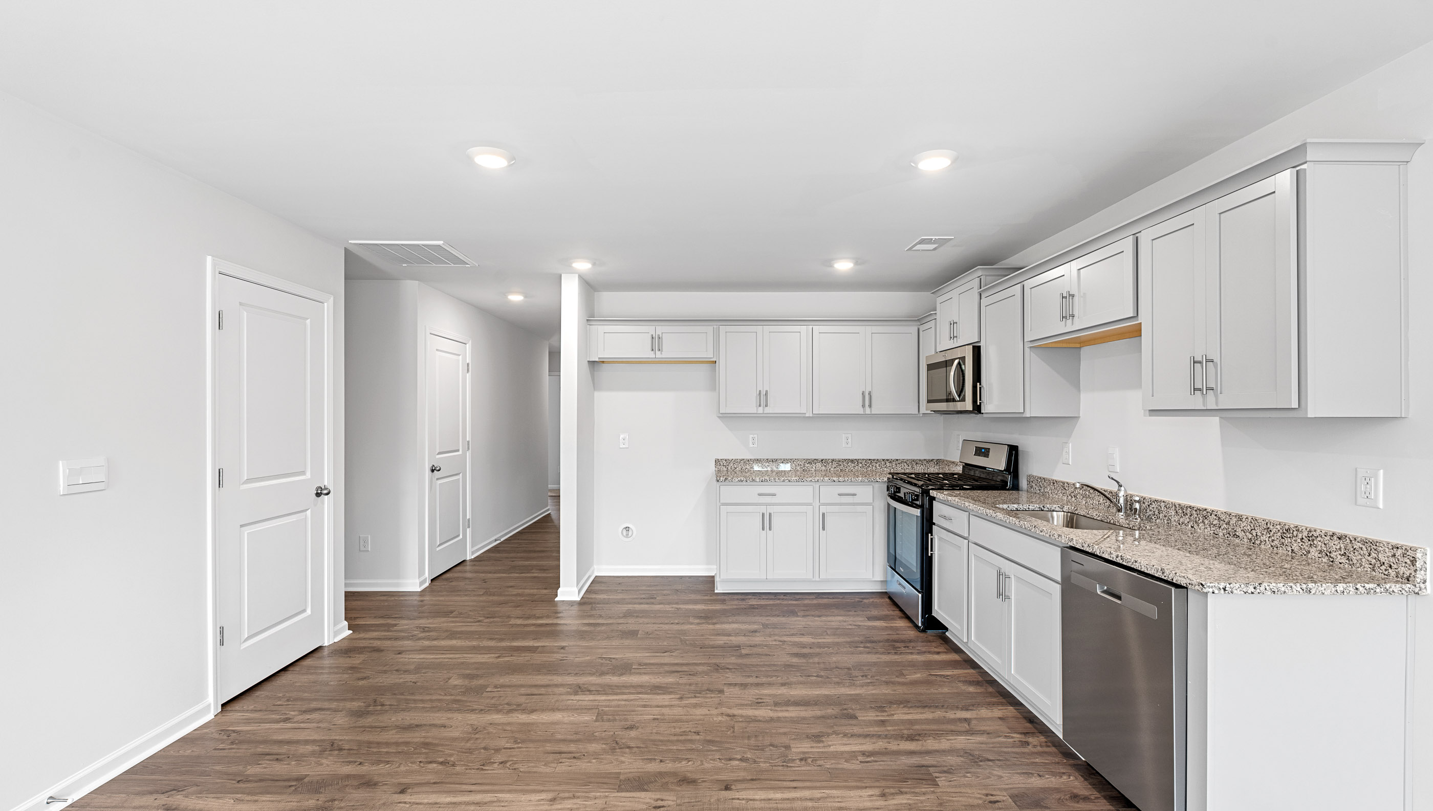 View of kitchen and hallway to the entrance.