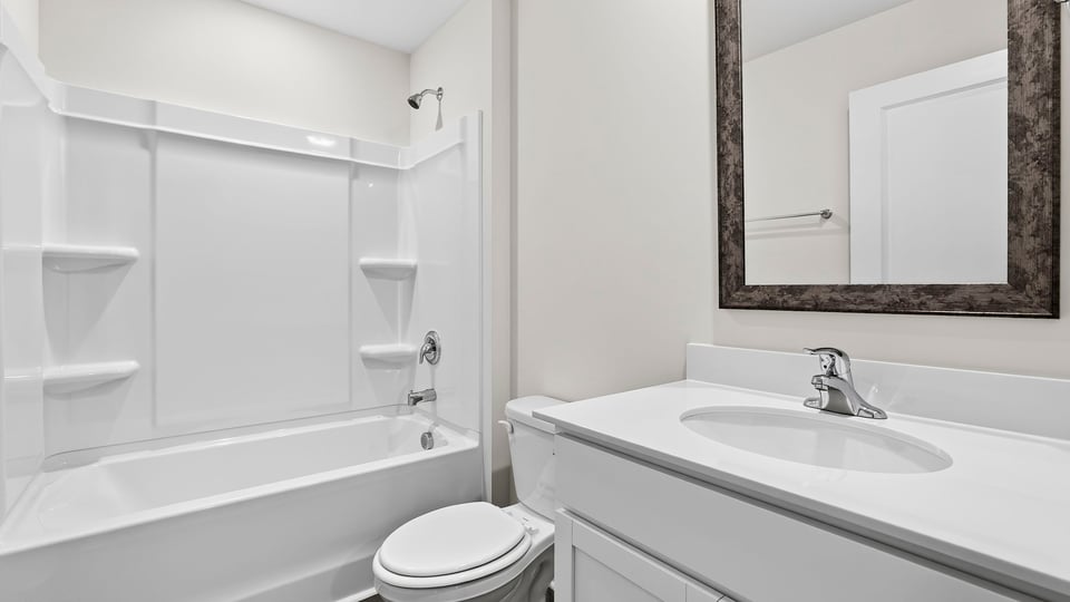 Bathroom with bathtub and single vanity sink.