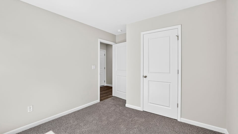 Bedroom with carpet and window.