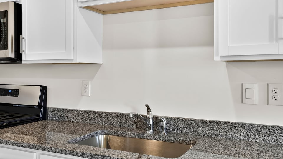 Kitchen with quartz countertops.
