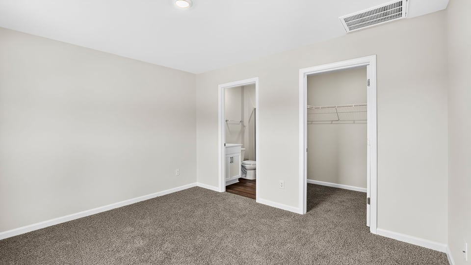 Bedroom with carpet and window.