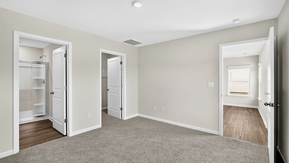 Bedroom with carpet and window.