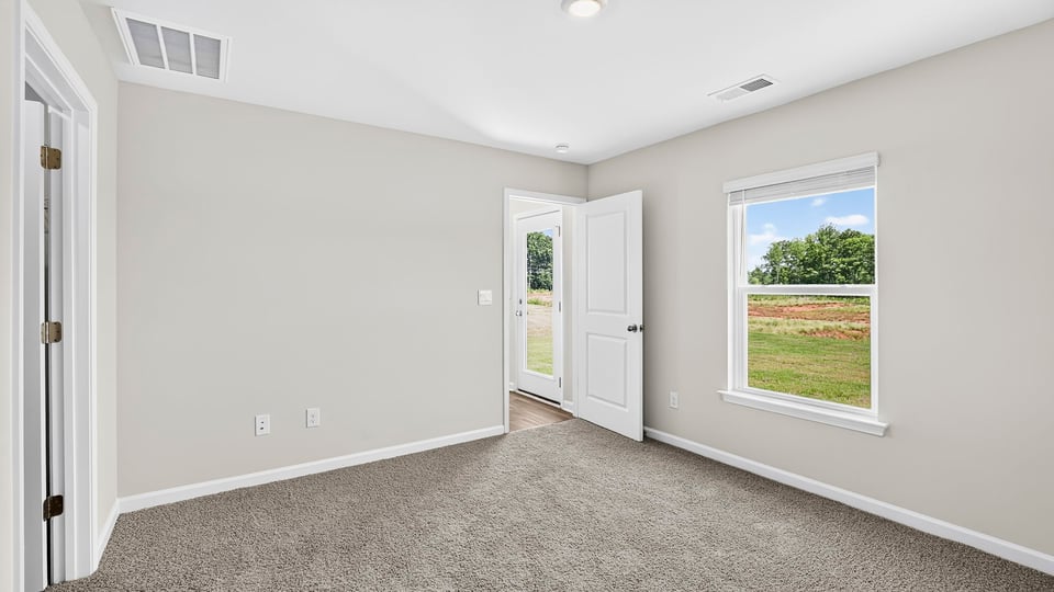 Bedroom with carpet and window.