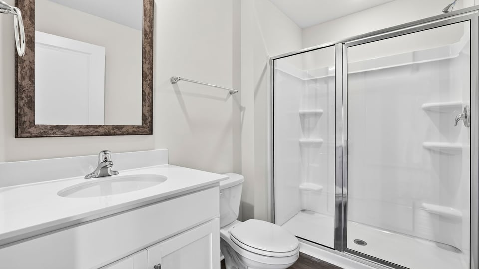 Bathroom with shower and single vanity sink.