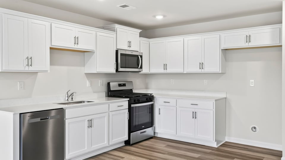 Kitchen with island and cabinets.