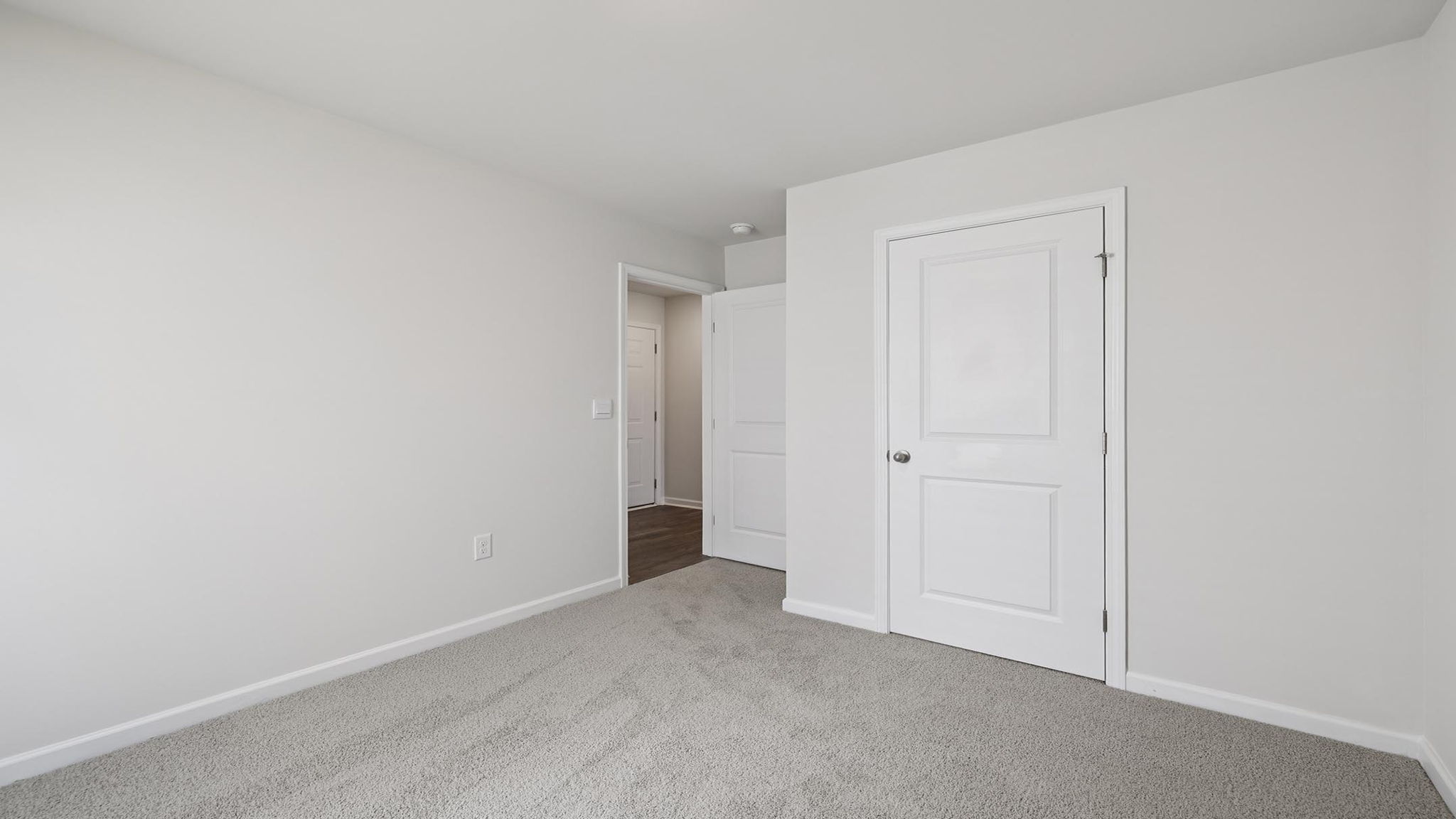 Bedroom with carpet and window.