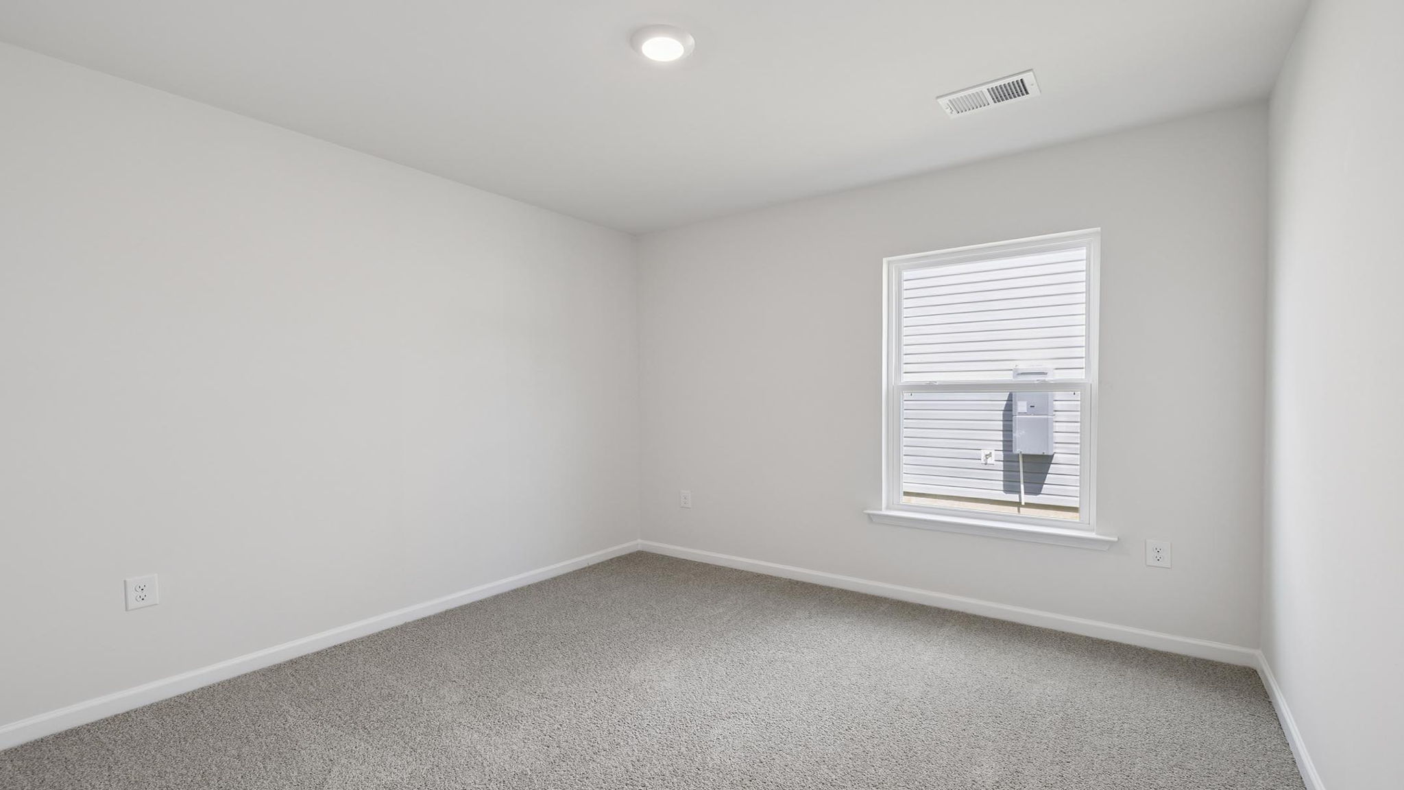 Bedroom with carpet and window.