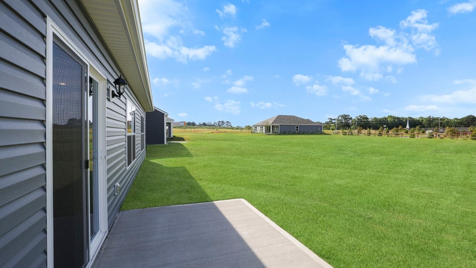 Back exterior with large backyard.