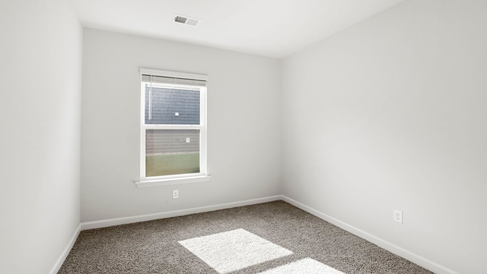 Bedroom with carpet and window.