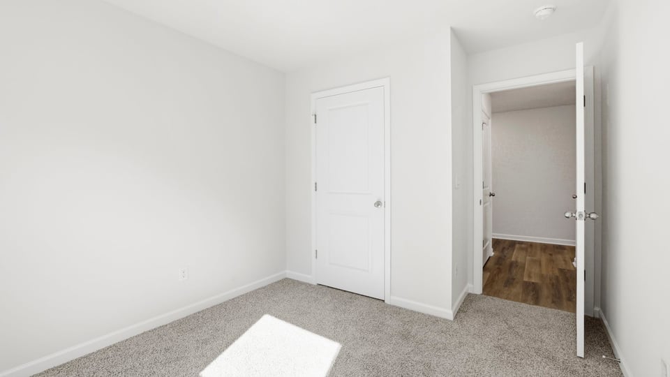 Bedroom with carpet and window.