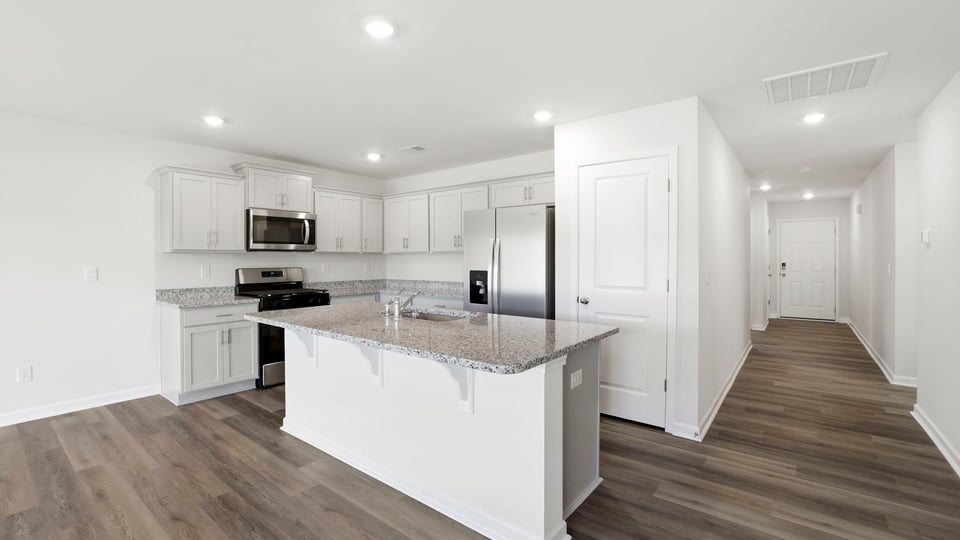 Bathroom with island and quartz countertops.