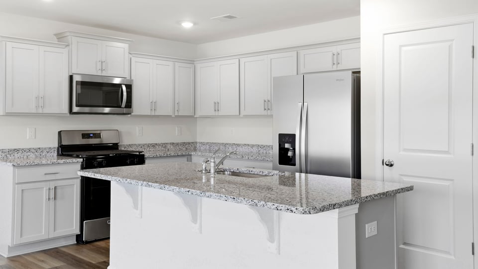 Bathroom with island and quartz countertops.