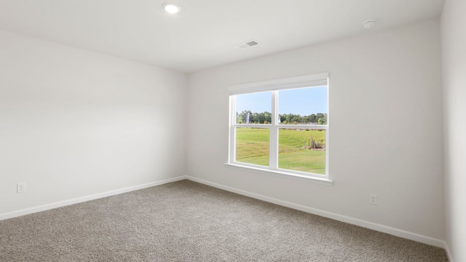 Bedroom with carpet and window.