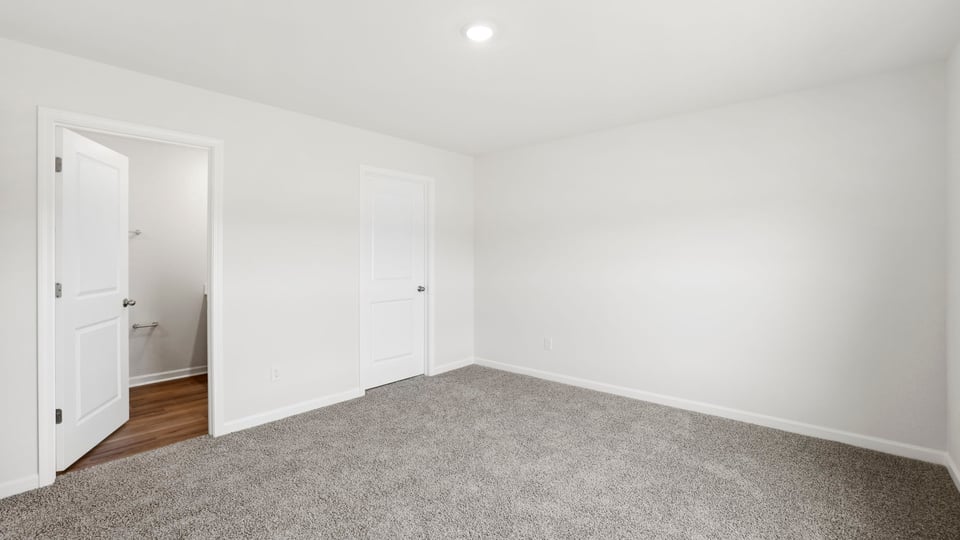 Bedroom with carpet and window.