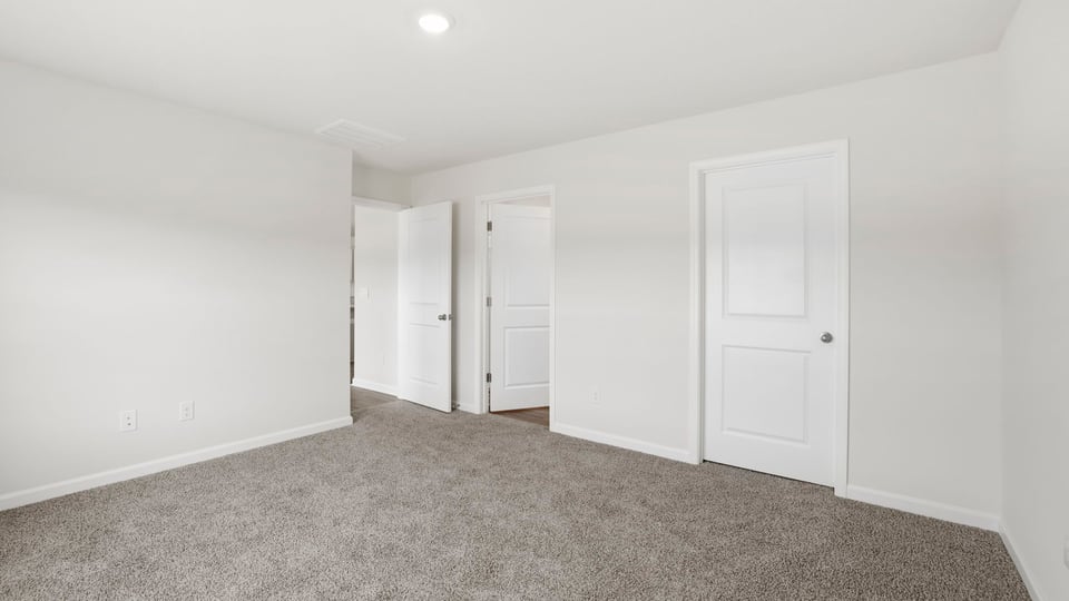 Bedroom with carpet and window.