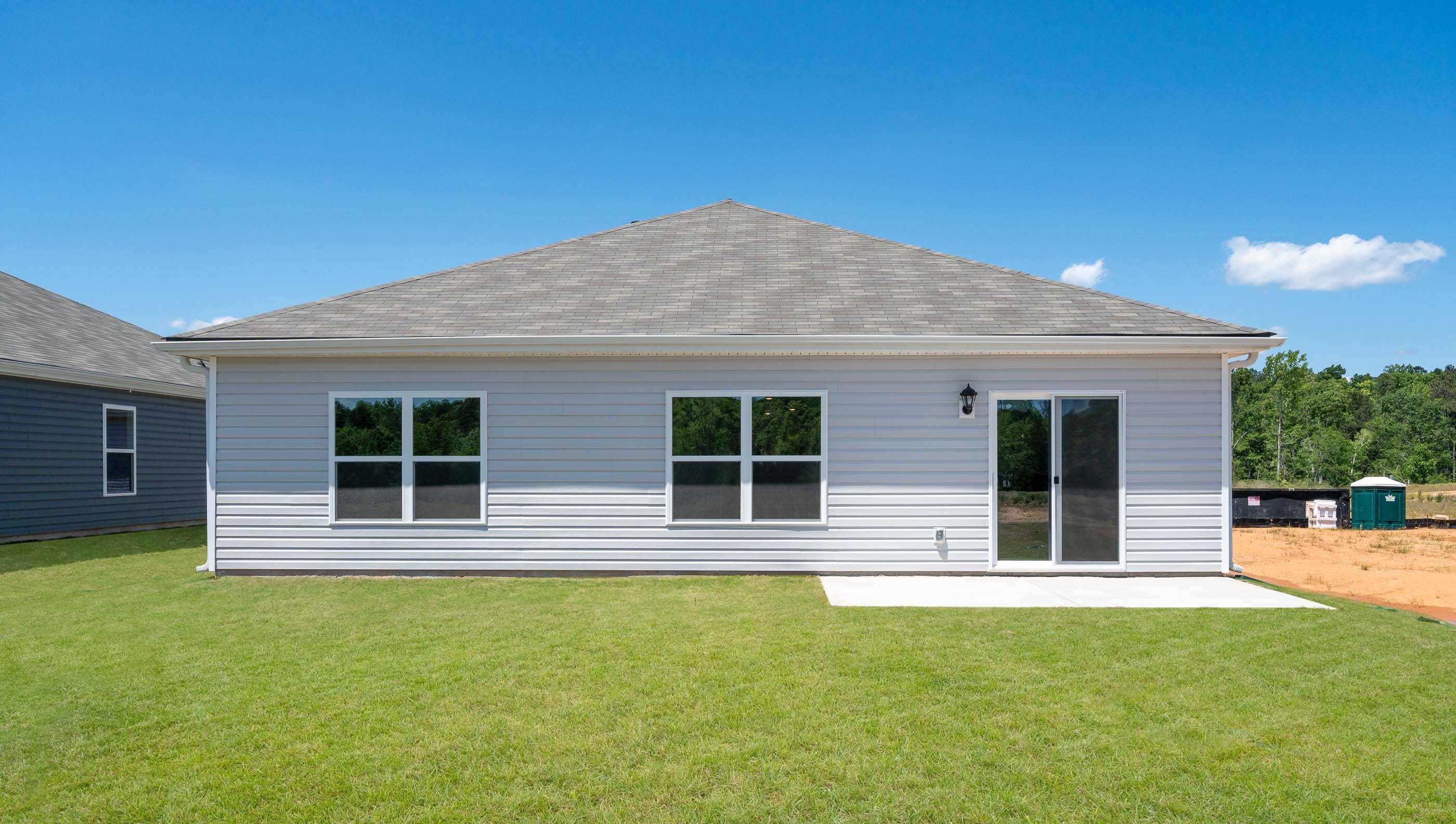 Back exterior of home with large backyard.