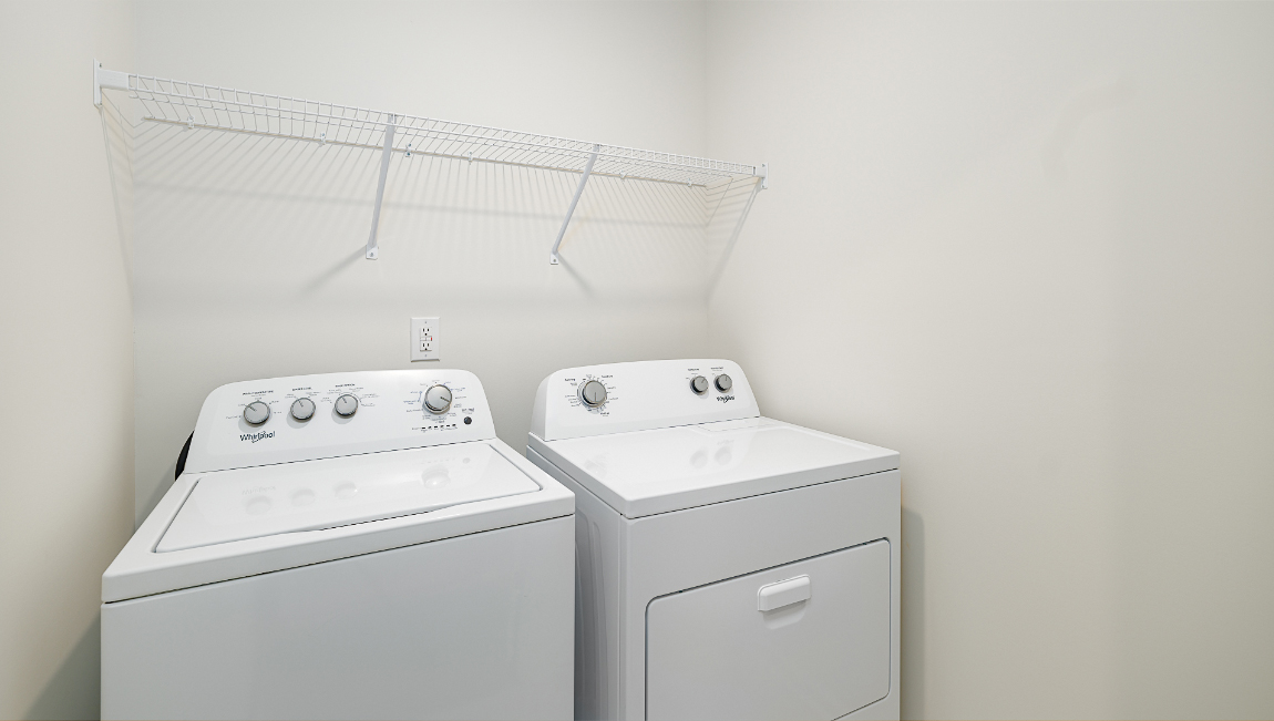 Laundry room with hanging storage racks.