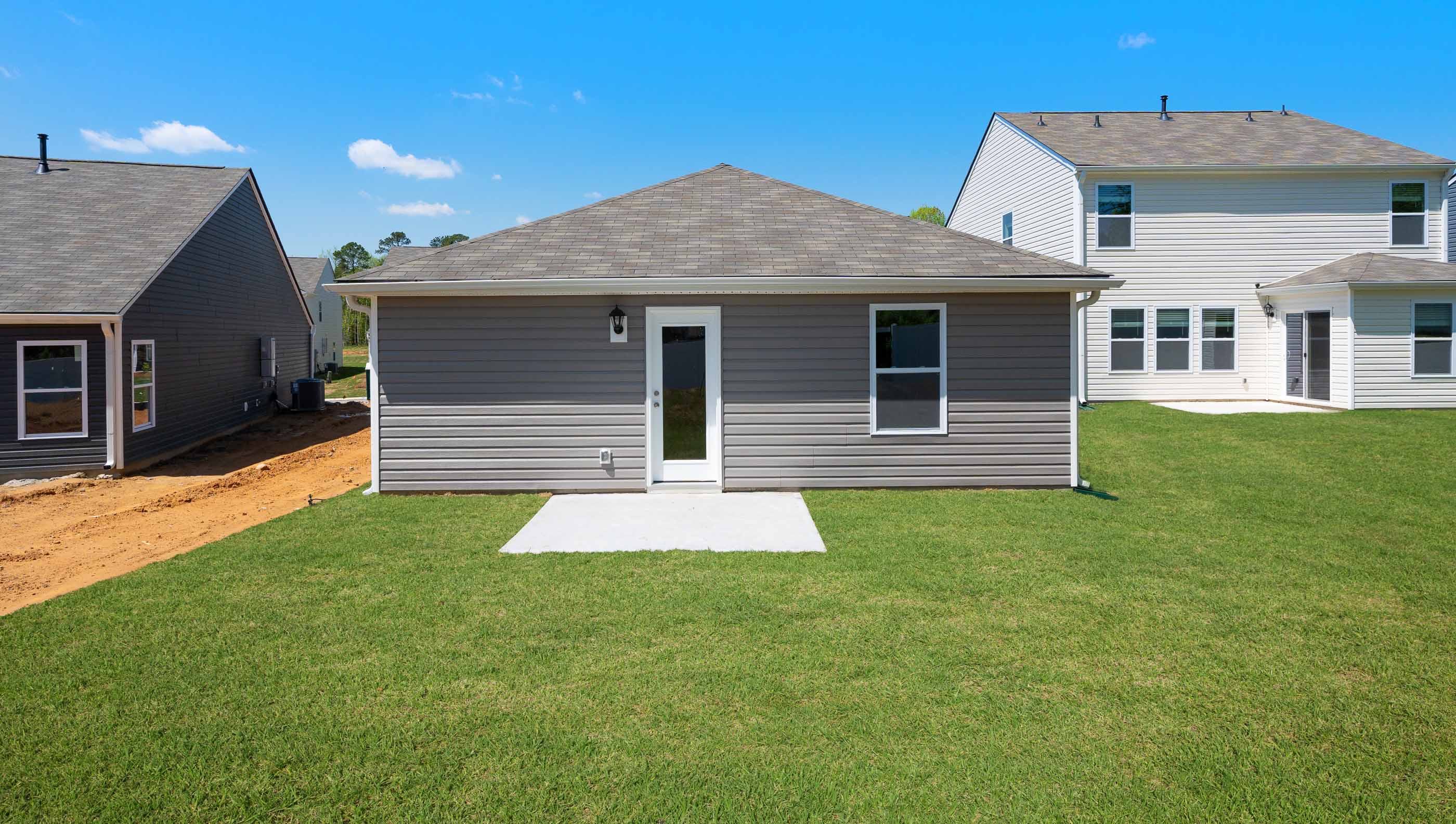 Back exterior with patio and large backyard,