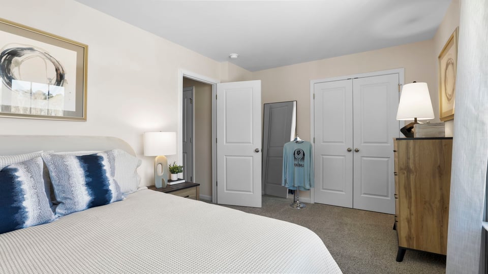 Bedroom with carpet and windows.