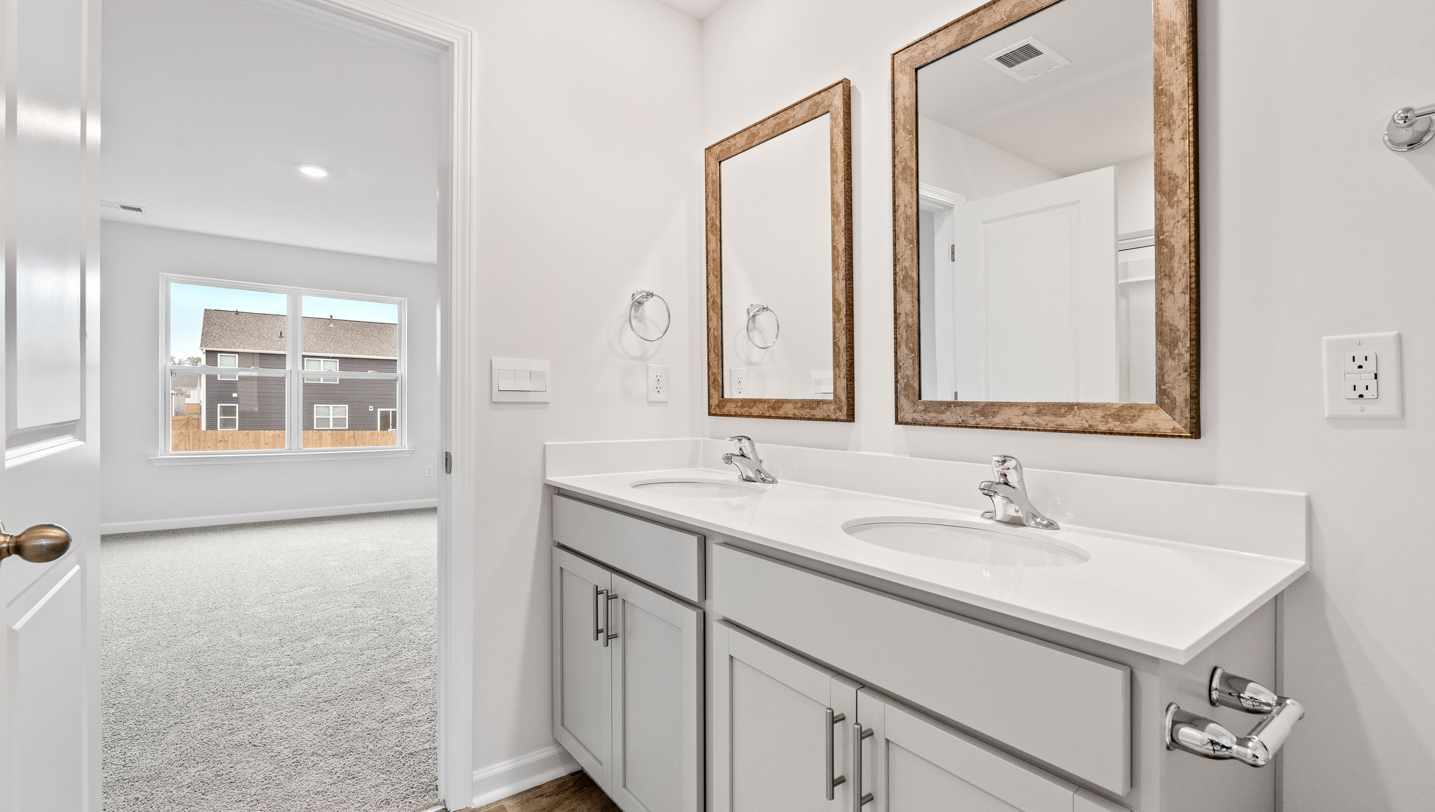 Primary bathroom with dual sink vanity.