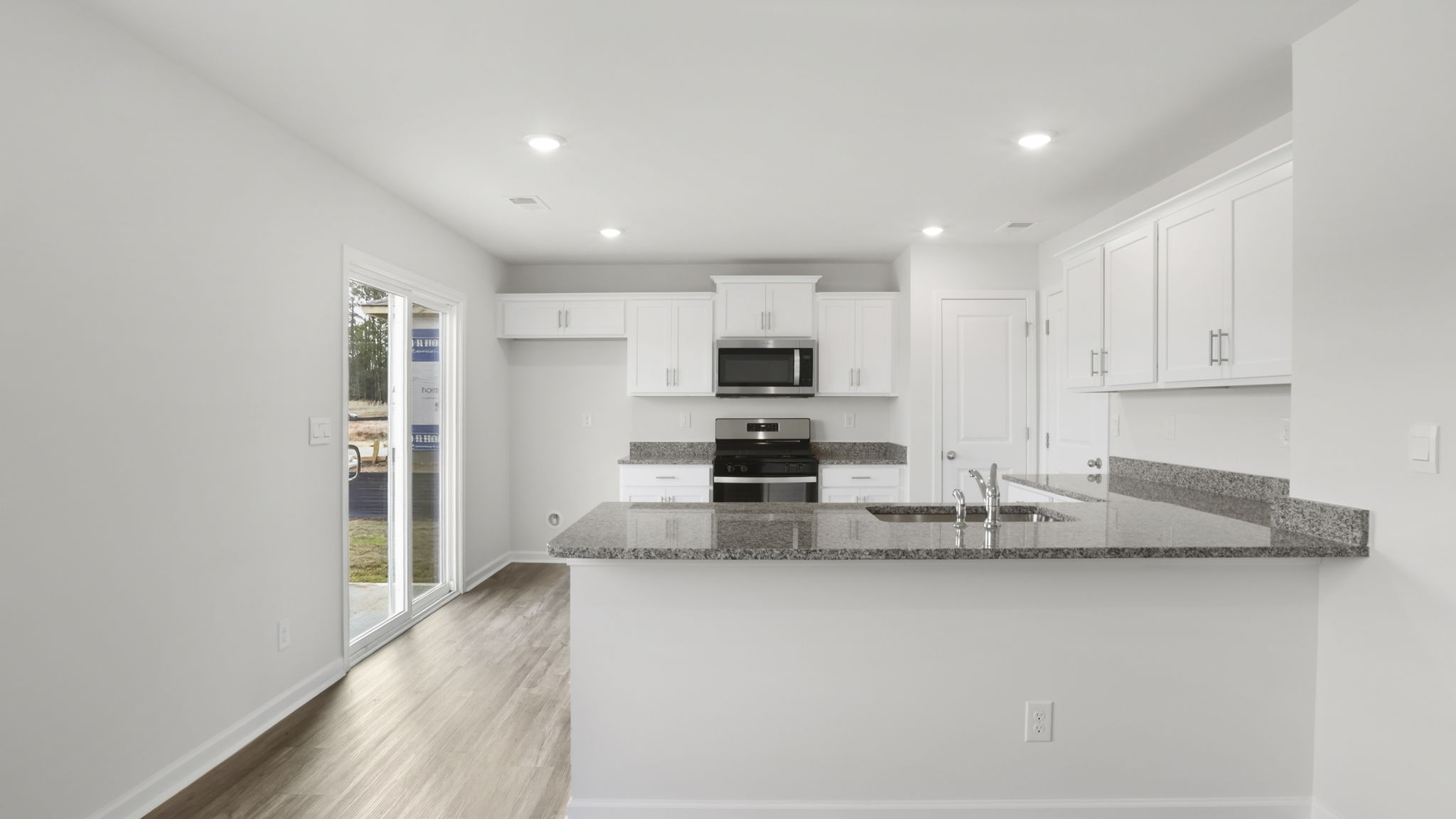 Kitchen with quartz countertops and stainless steel appliances.