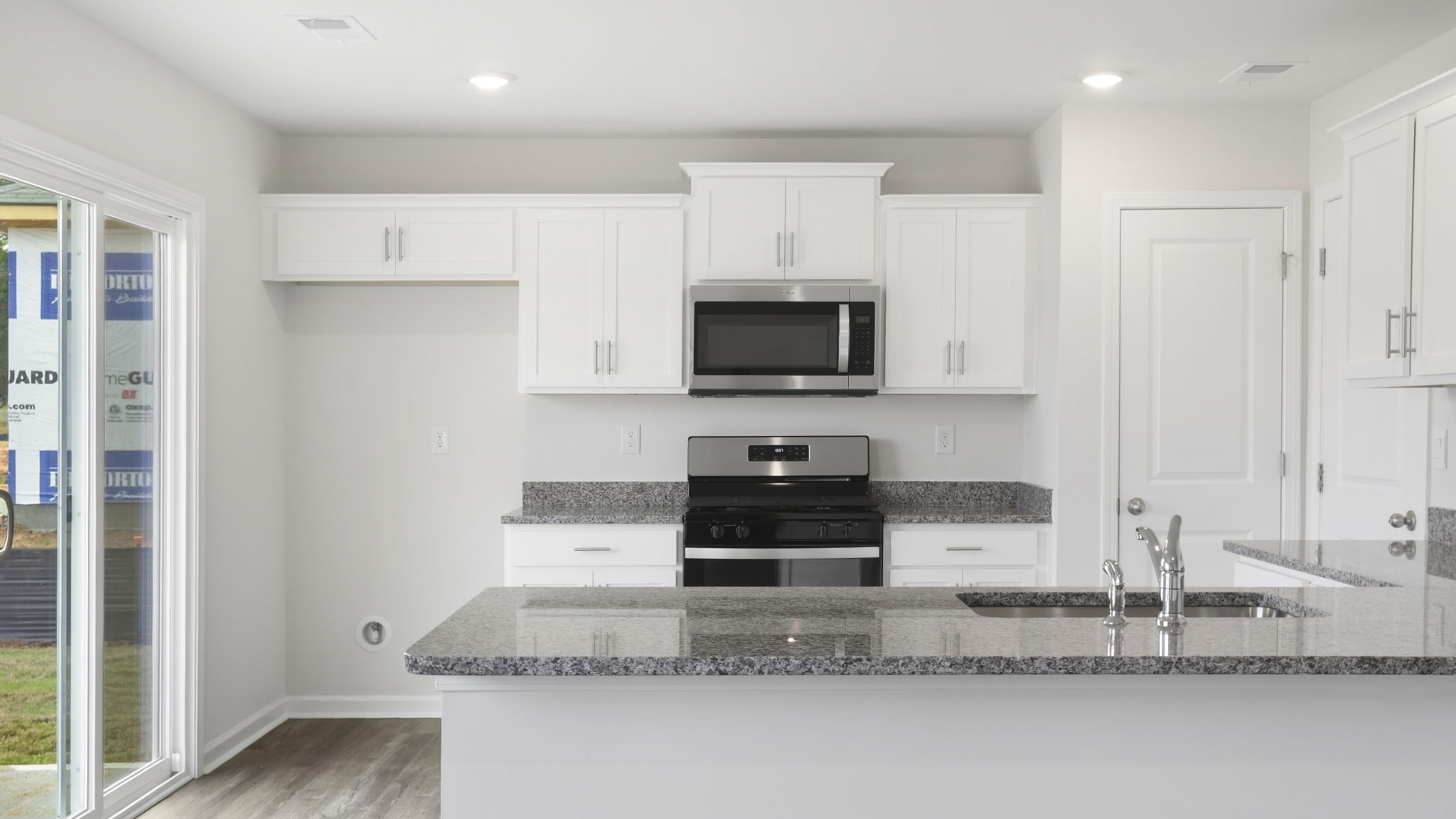 Kitchen with quartz countertops and stainless steel appliances.