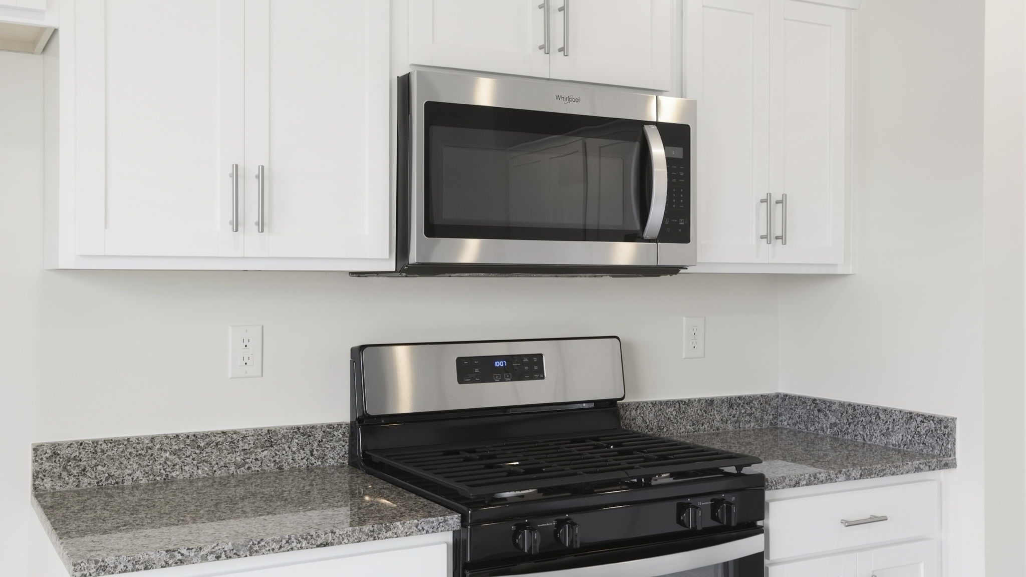 Kitchen with quartz countertops and stainless steel appliances.