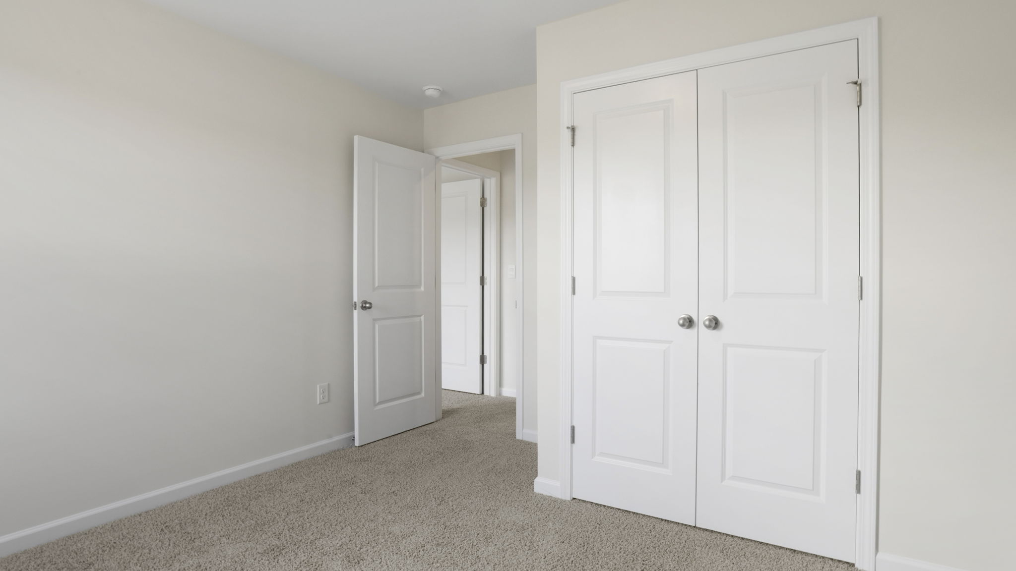 Bedroom with carpet and window.