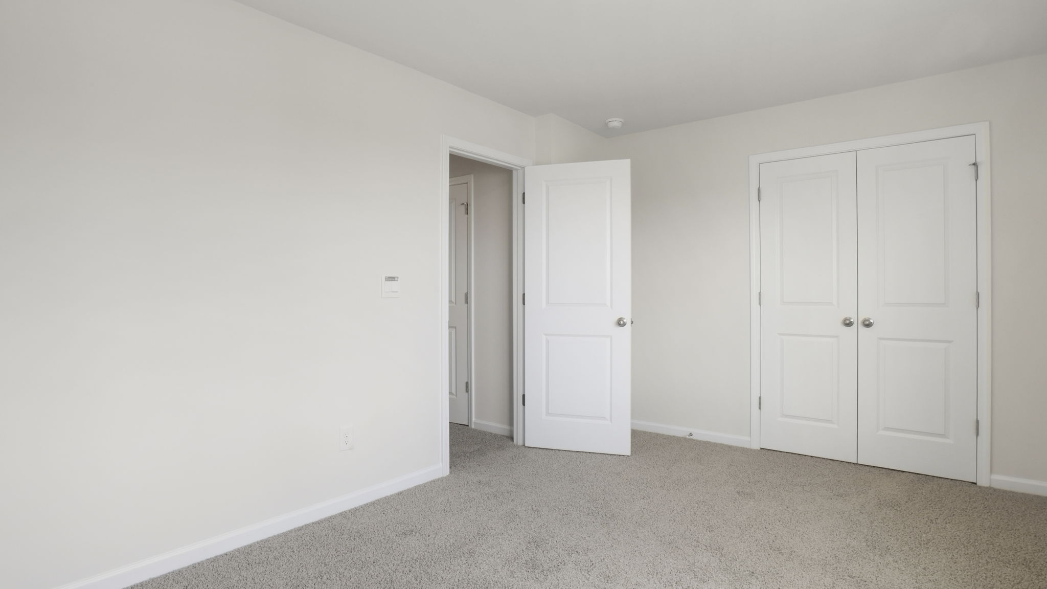 Bedroom with carpet and window.