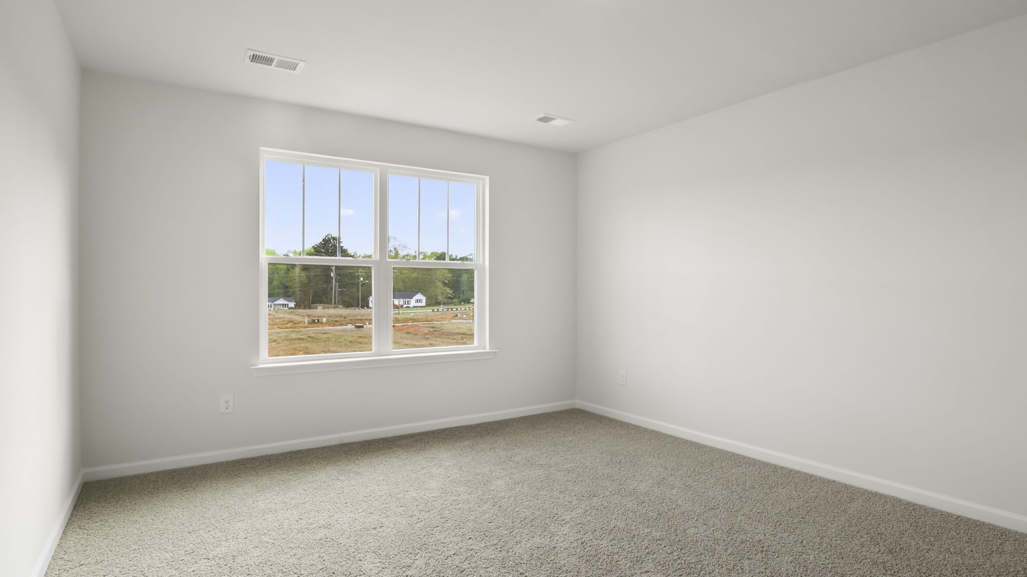 Bedroom with carpet and window.