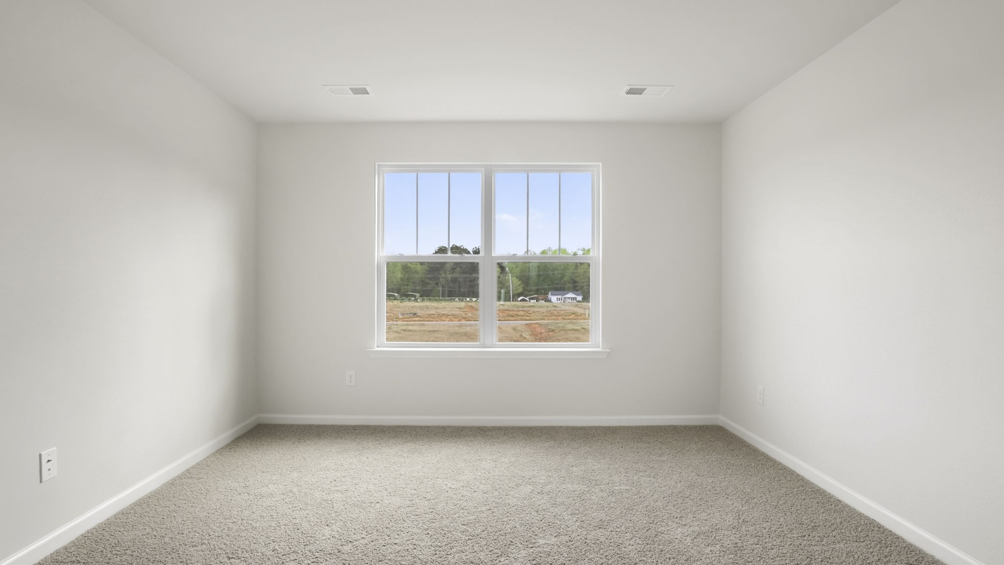 Bedroom with carpet and window.