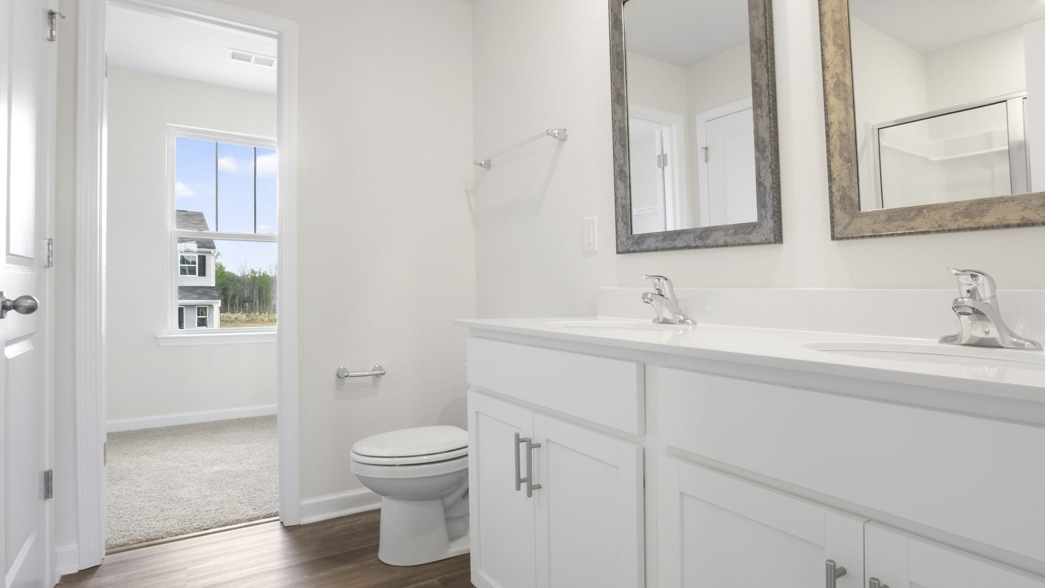 Bathroom with double vanity sink and tub.