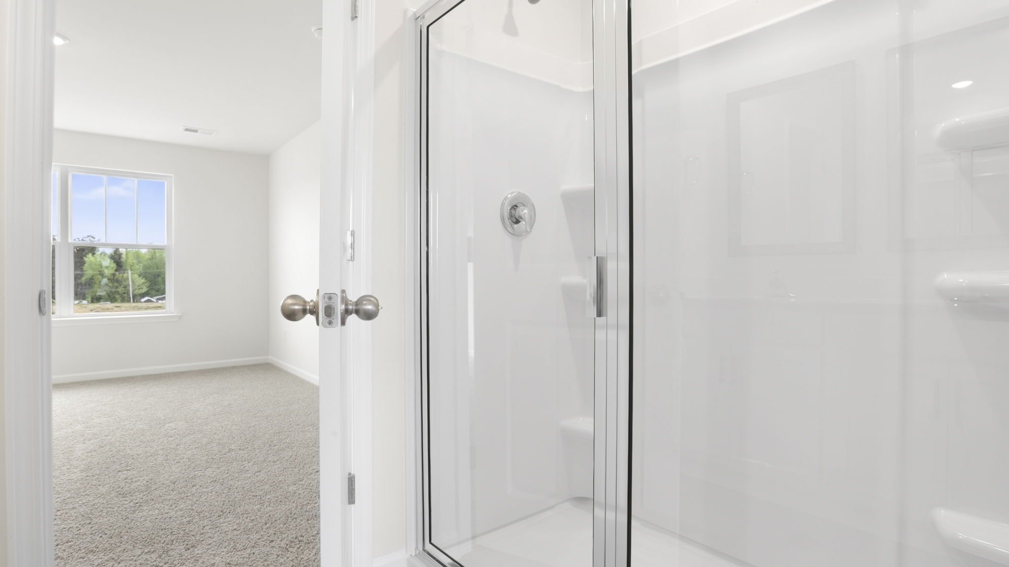 Bathroom with double vanity sink and tub.
