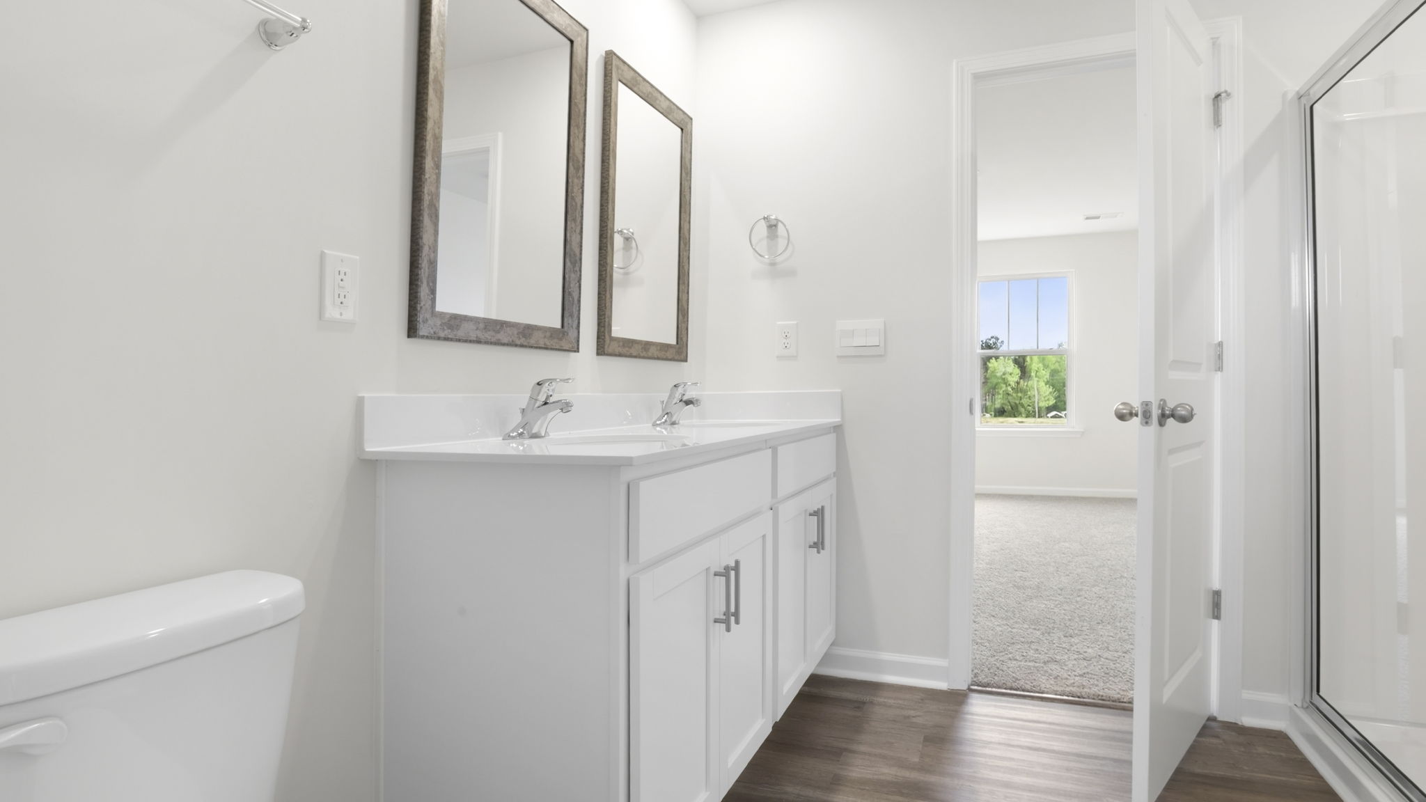 Bathroom with double vanity sink and tub.