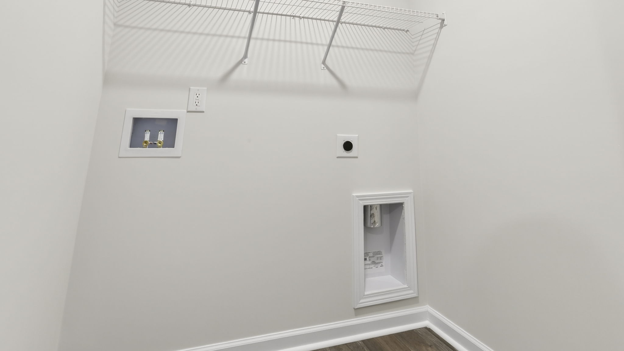 Laundry room with hanging storage racks.