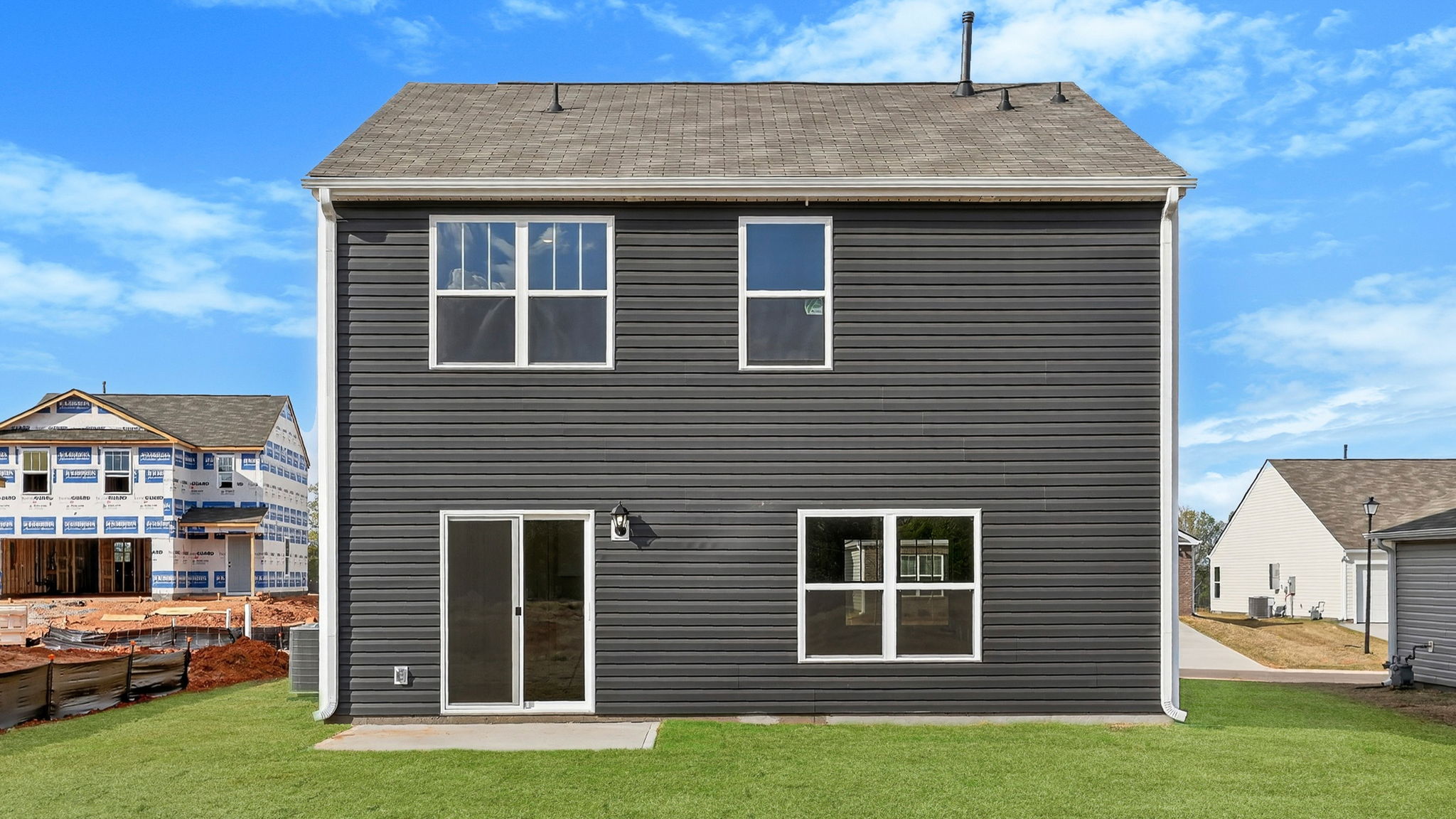 Back exterior of home with large backyard.