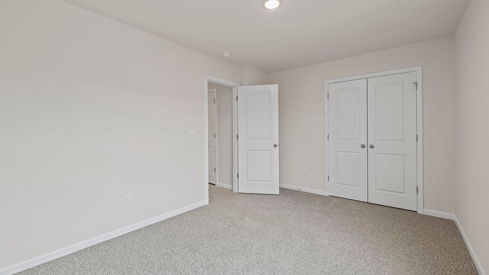 Bedroom with window and carpet.