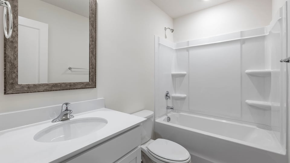 Hall bathroom with dual sink vanity with shower / tub.