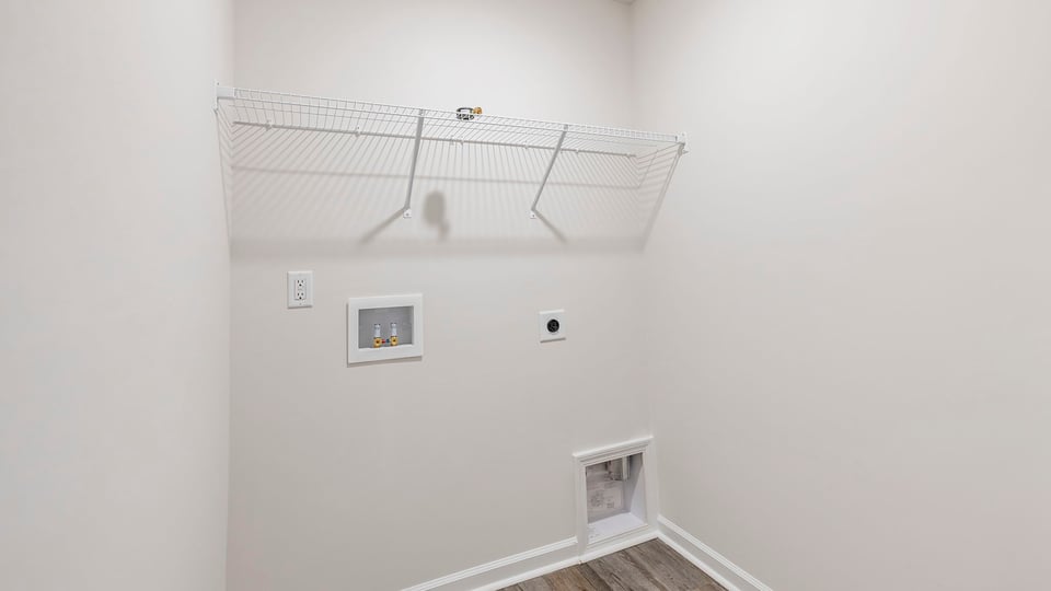 Walk-in laundry room with shelving.