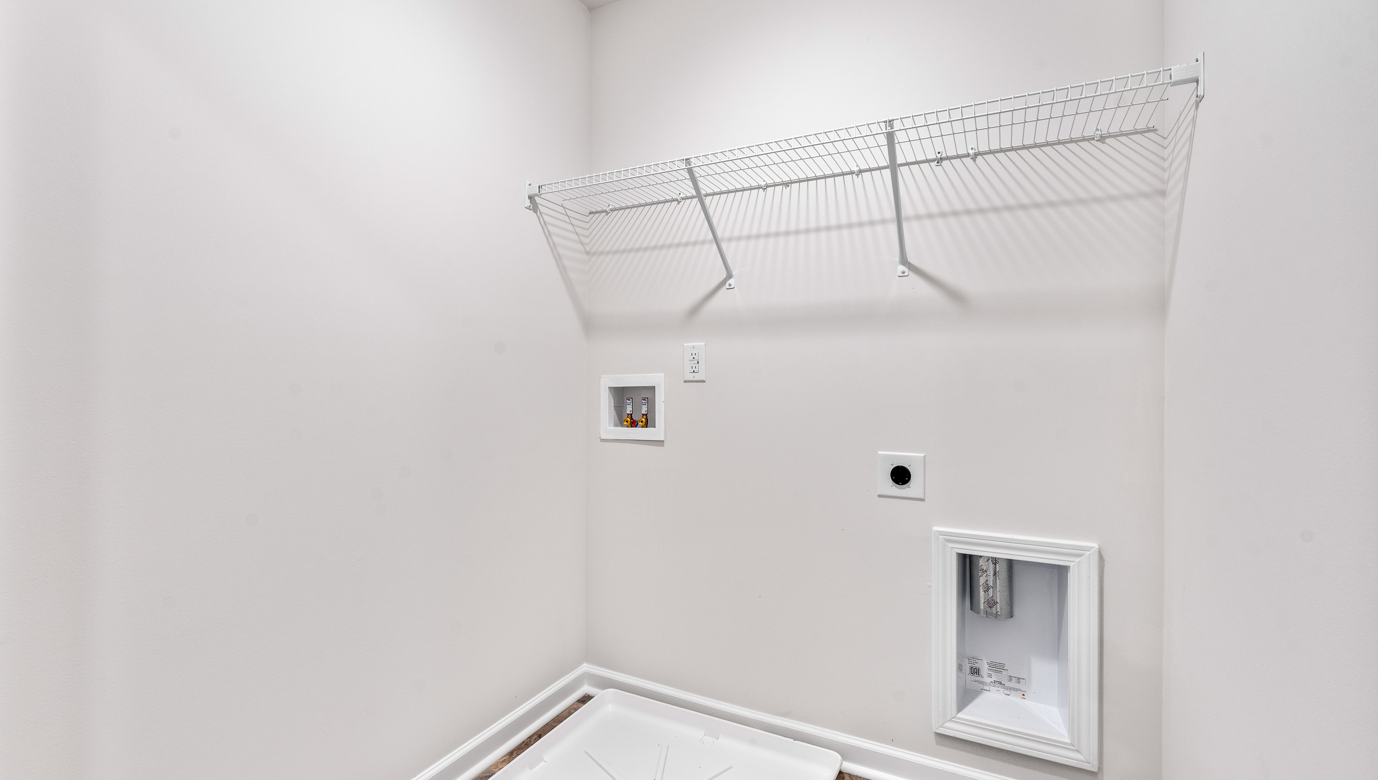 Laundry room with shelf.
