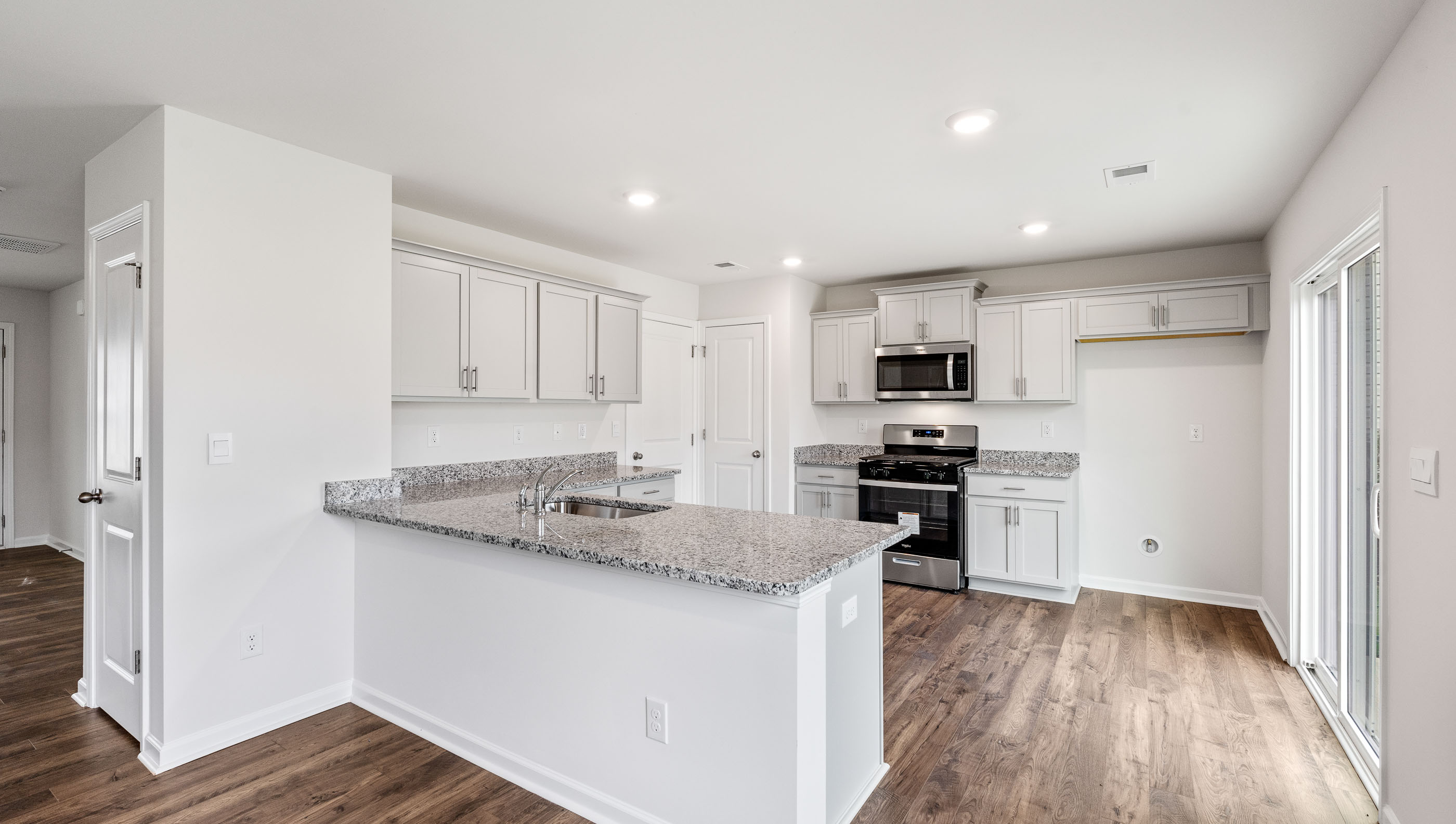 Kitchen with cabinets and windows.