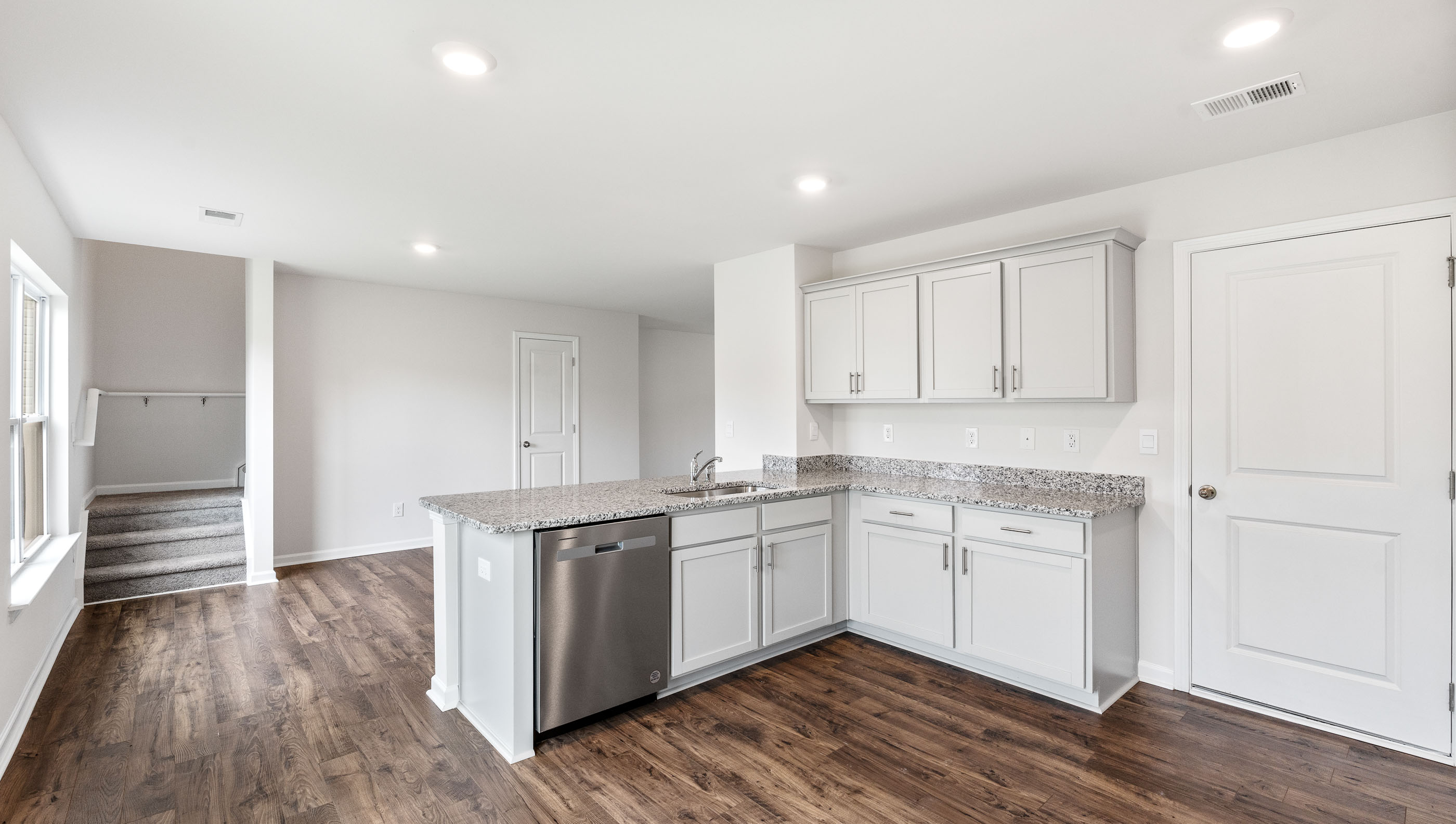 Kitchen with cabinets and windows.