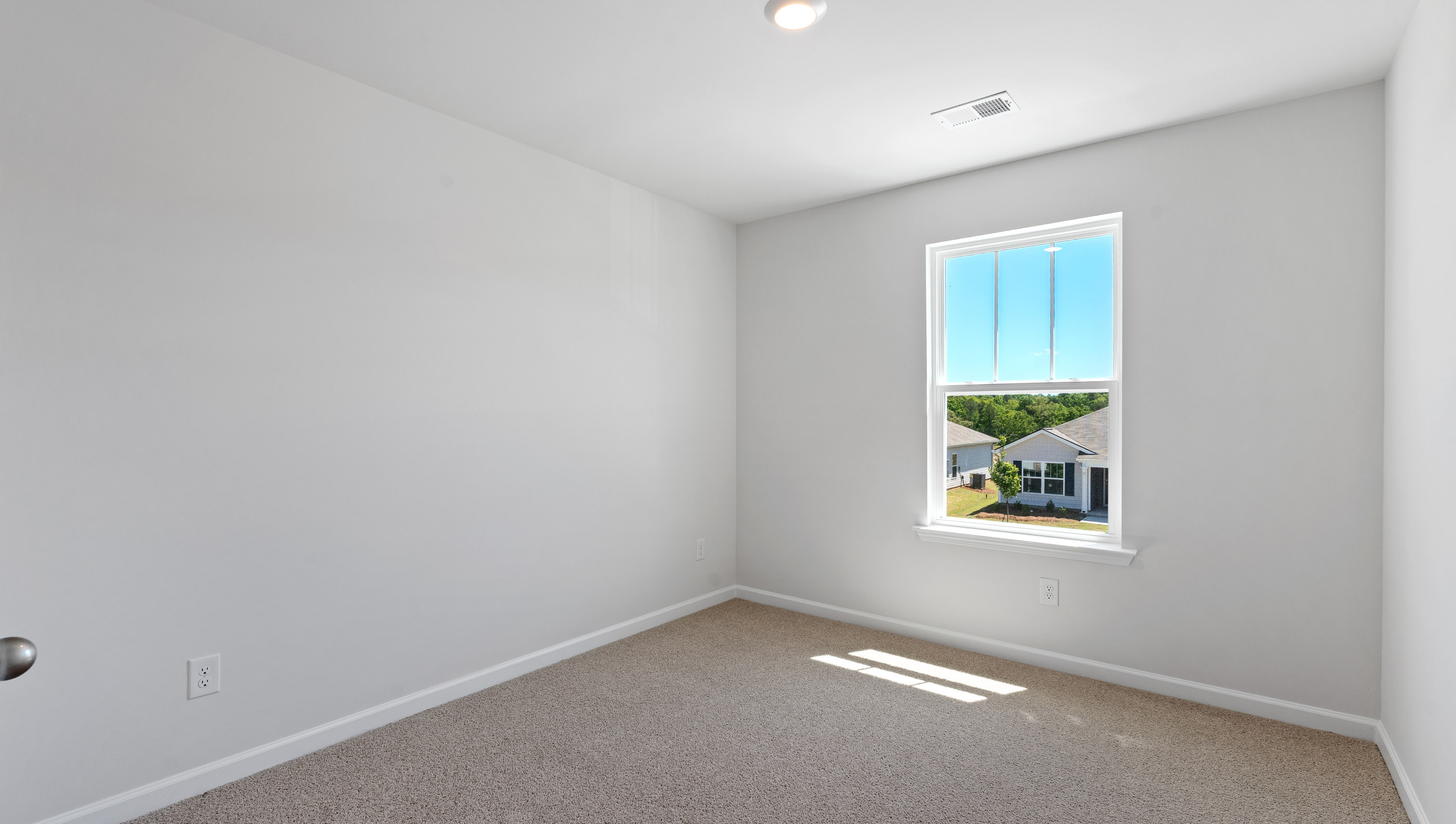 Bedroom with carpet and windows.