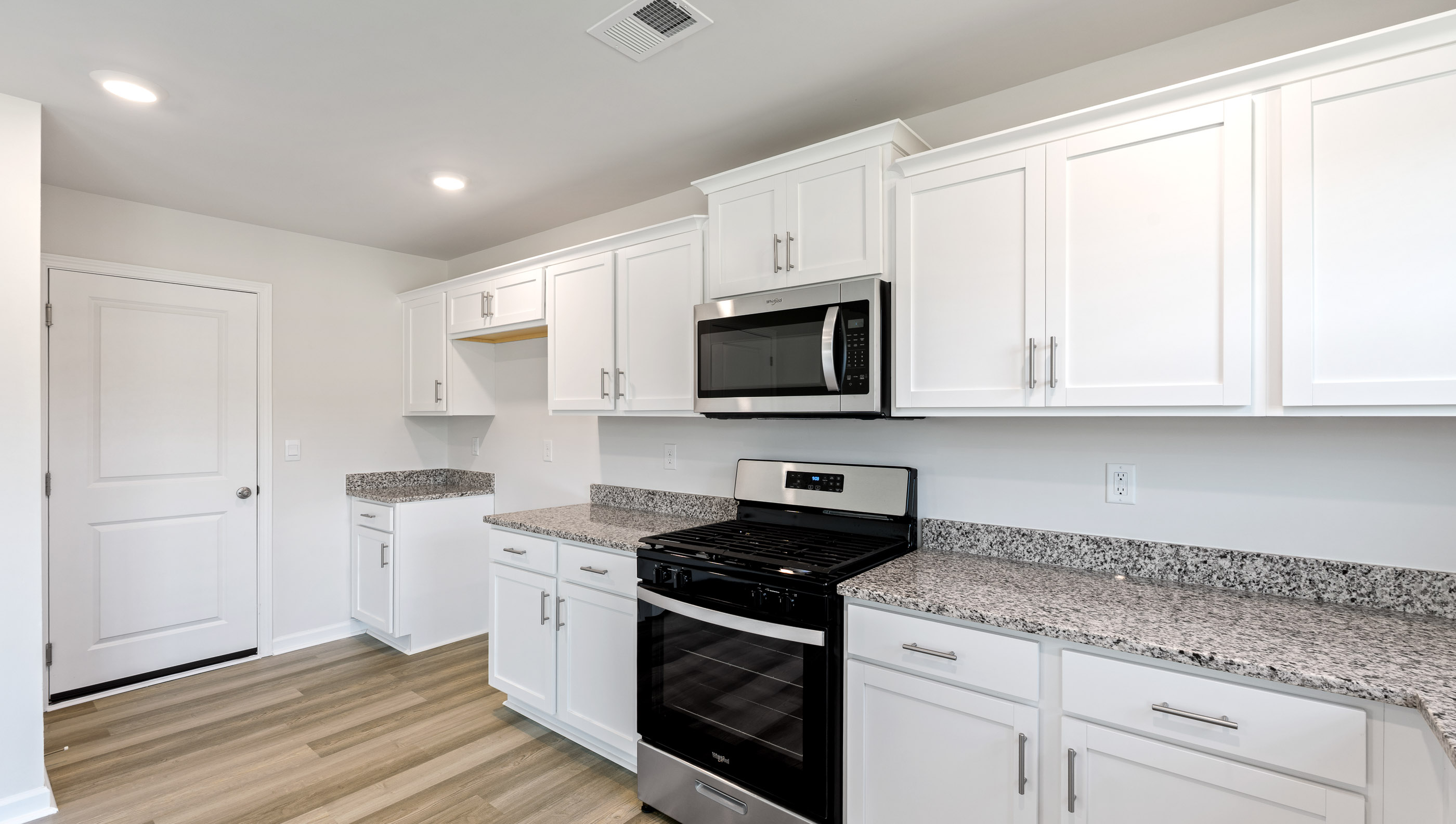 Kitchen with cabinets and windows.