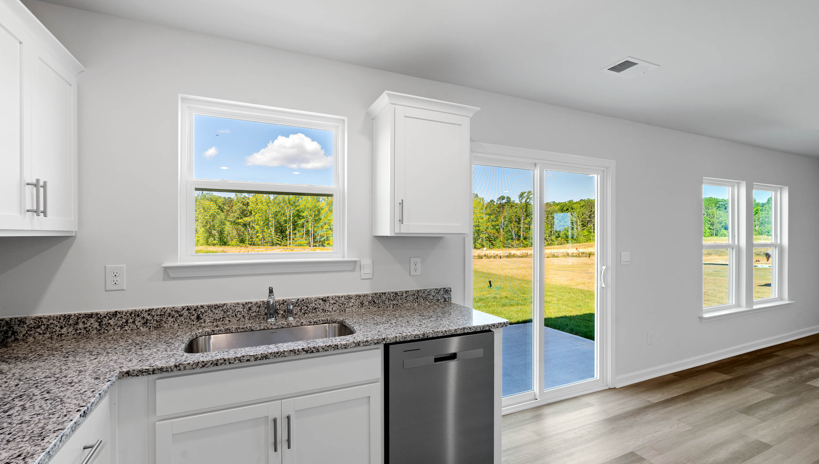 Kitchen with cabinets and windows.