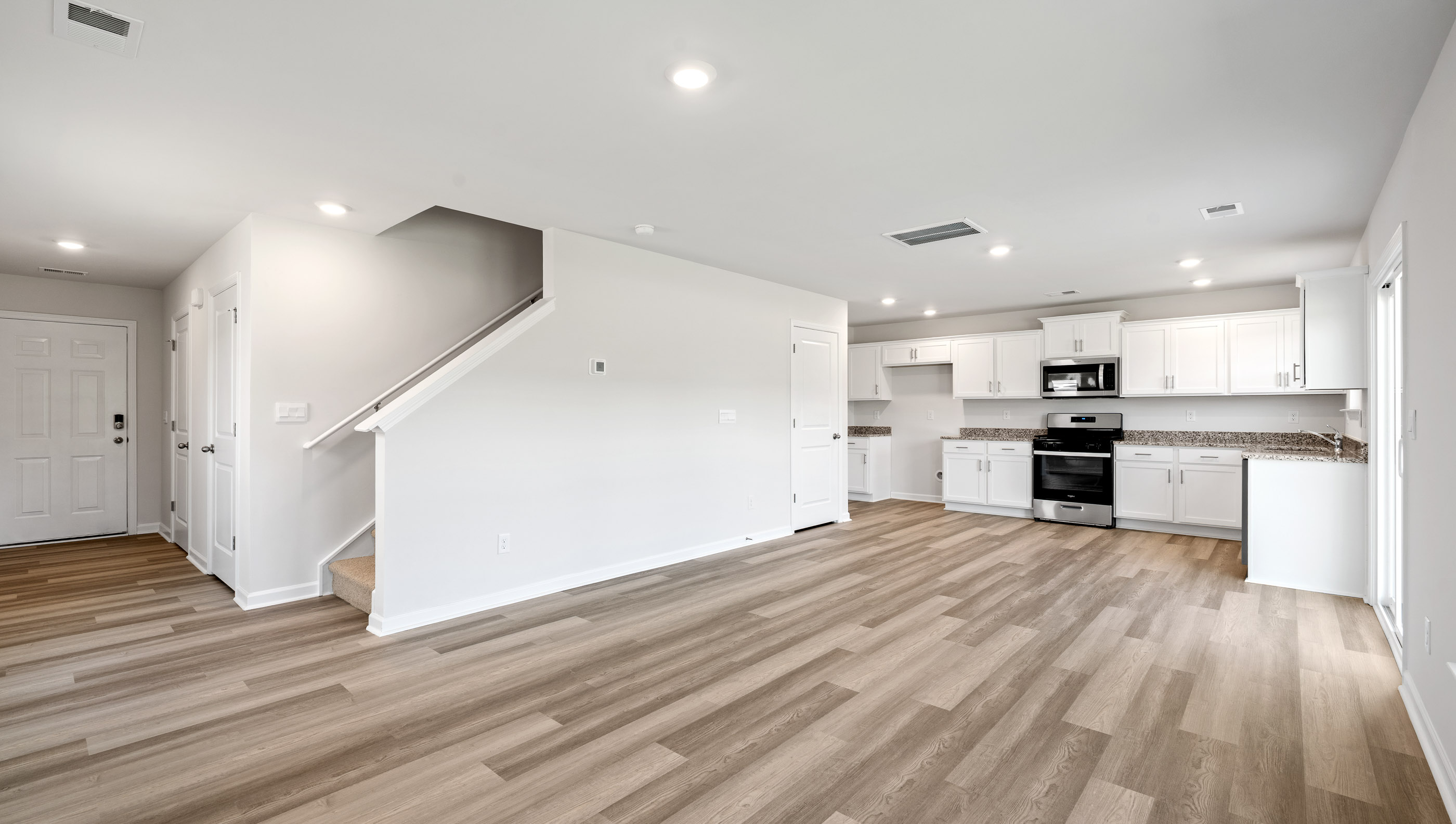 Family room with windows and view of kitchen.